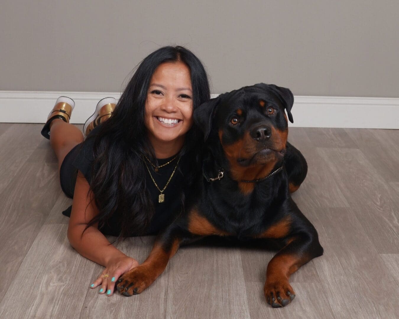 Woman smiling with her Rottweiler dog.