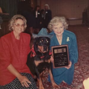 Two women with award-winning Rottweiler.
