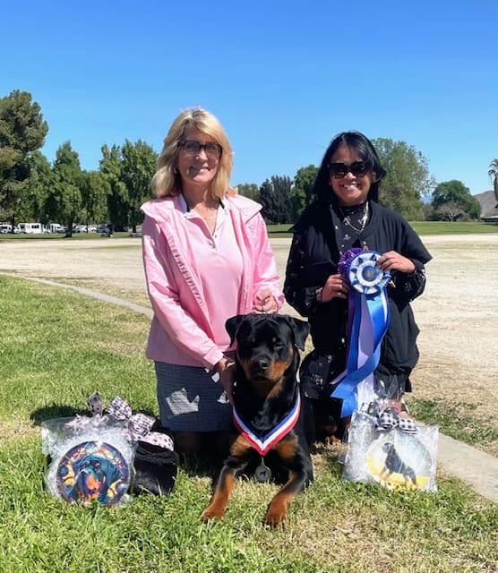 Two women with award-winning Rottweiler dog.